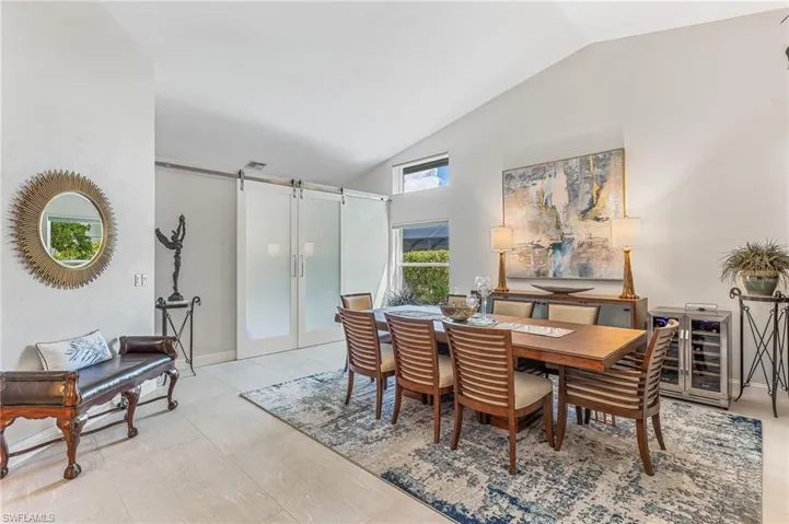 Elegant dining and behind frosted barn door slider is a den...see next photo