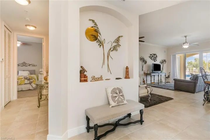 Hallway with baseboards and light tile patterned flooring