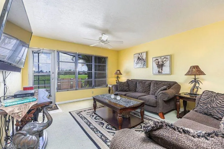 Living room featuring baseboards and ceiling fan