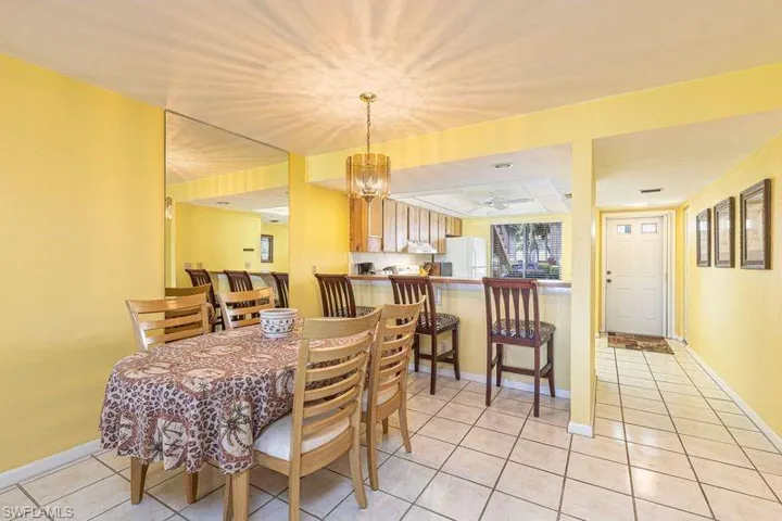 Dining space featuring hanging lights, light tile patterned flooring, and ceiling fan