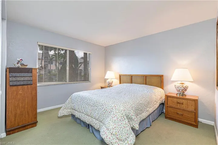 Bedroom with baseboards and carpet flooring