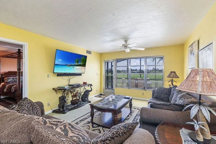 Living room with a textured ceiling and ceiling fan