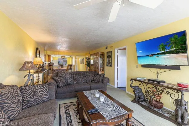 Living room with a textured ceiling and baseboards