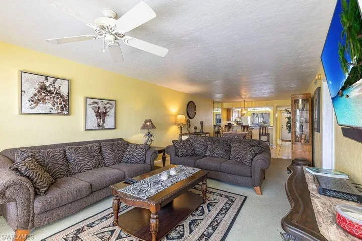 Living room featuring a textured ceiling and a ceiling fan