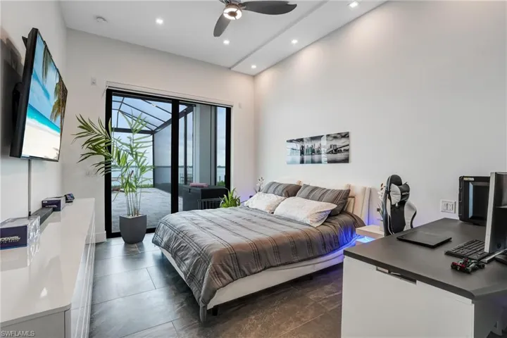 Bedroom with access to exterior, recessed lighting, a desk, and ceiling fan