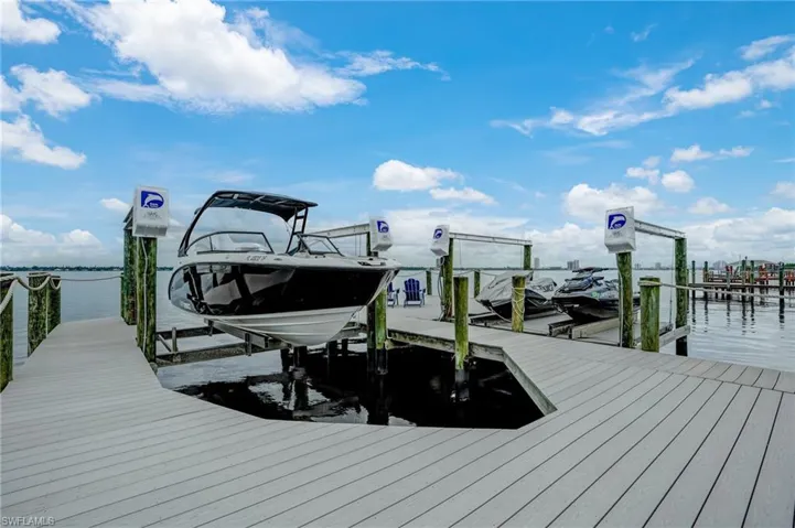 Dock area featuring boat lift and a water view