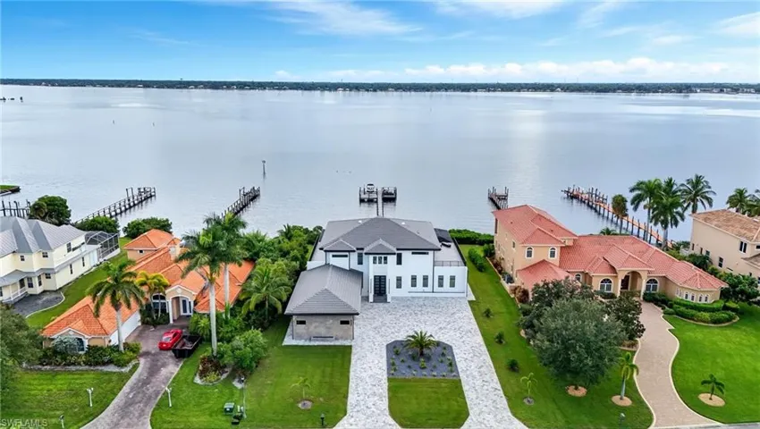 Aerial perspective of suburban area featuring a nearby body of water