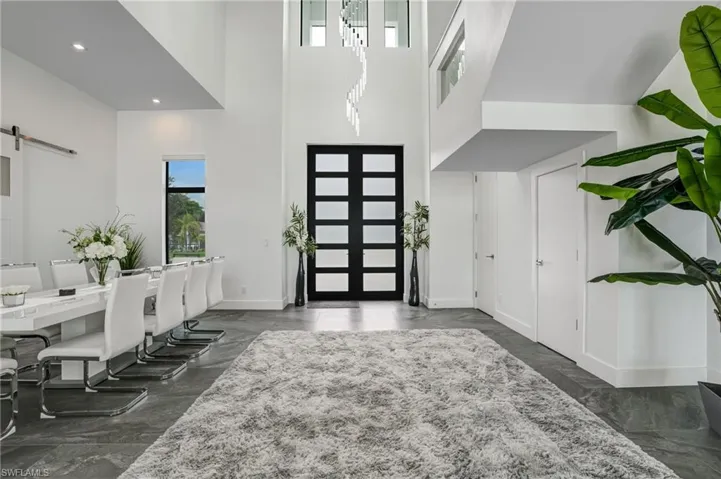 Foyer featuring a barn door, a high ceiling, and recessed lighting