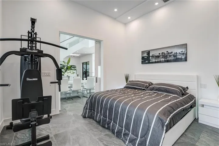 Bedroom with recessed lighting and a towering ceiling