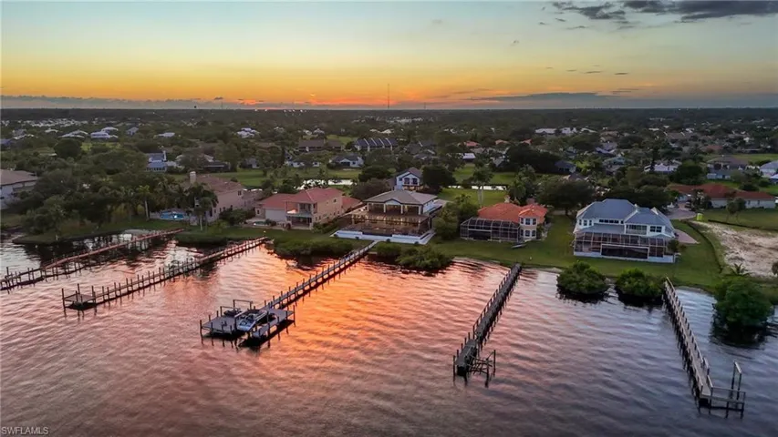 Aerial perspective of suburban area featuring a large body of water