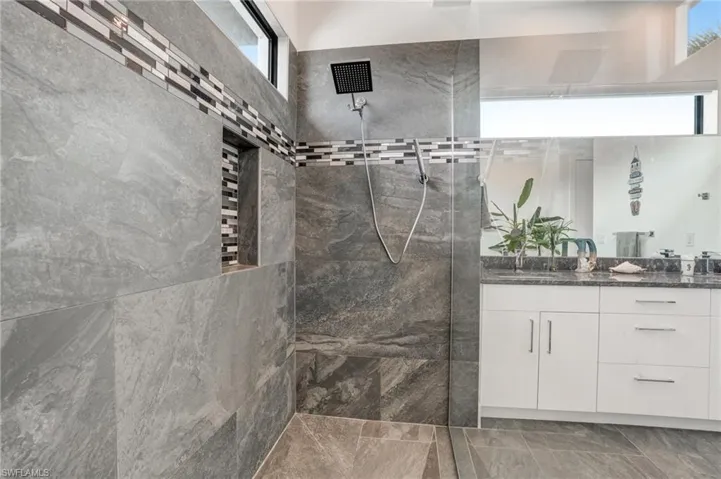 Full bathroom with vanity and walk in shower