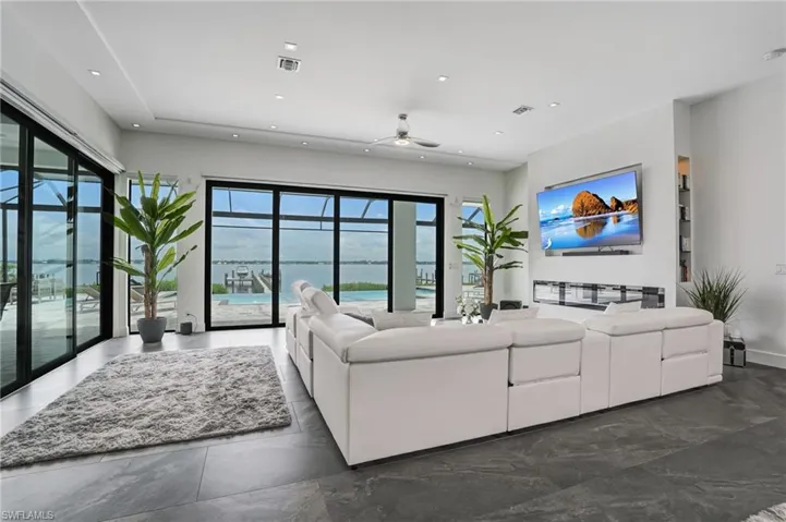 Living area featuring a ceiling fan and recessed lighting