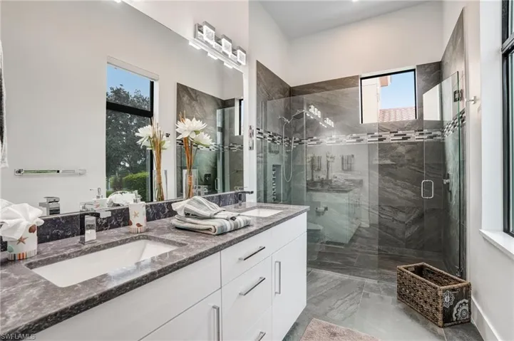 Bathroom with a shower stall and double vanity