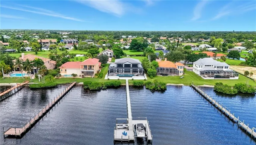 Aerial perspective of suburban area with a large body of water