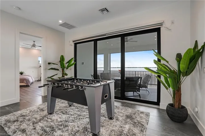 Game room featuring a ceiling fan, a water view, and recessed lighting