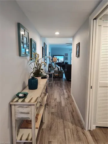 Corridor featuring wood-type flooring