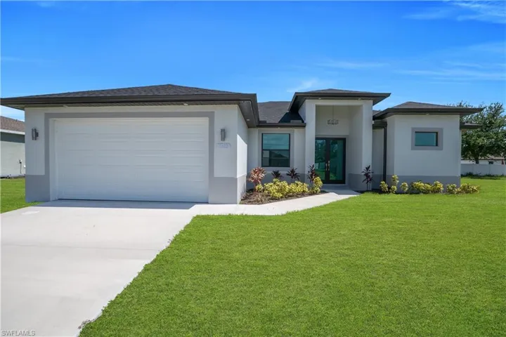 Modern stucco home with a prominent two-car garage