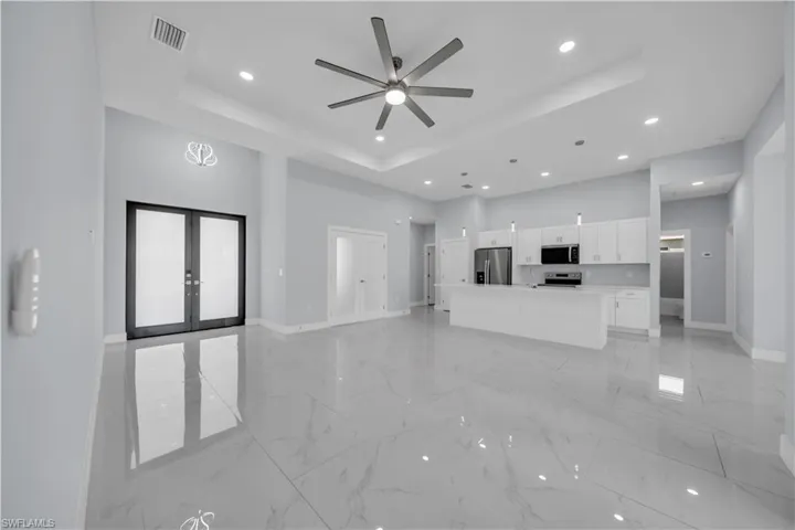 Open-concept living space with polished tile flooring