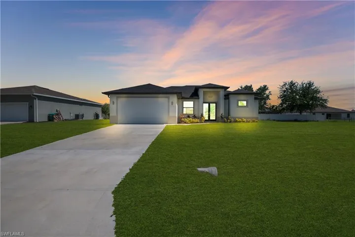 Contemporary-style single-story residence with a concrete driveway and an attached two-car garage