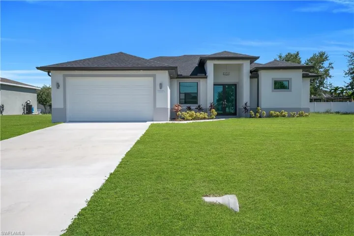 Contemporary stucco exterior with a dark shingle roof
