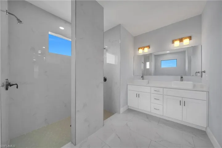 Dual vanity featuring rectangular vessel sinks, white cabinetry, and quartz countertops