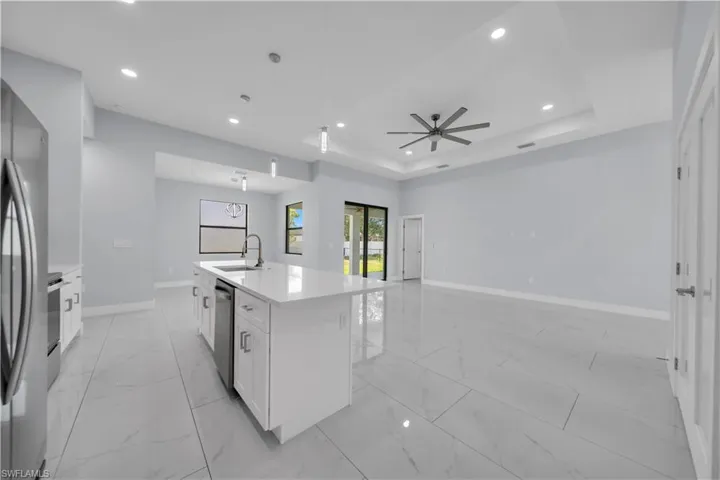 Open-concept interior featuring large format tile flooring throughout