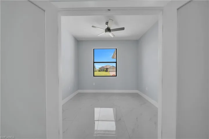 Room featuring a centered window, a ceiling fan, and light gray walls