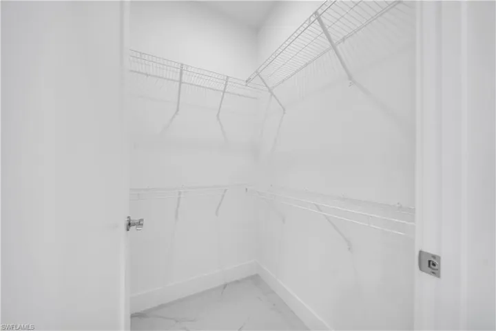 Walk-in closet featuring white wire shelving