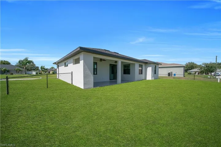 Expansive green lawn surrounds the property