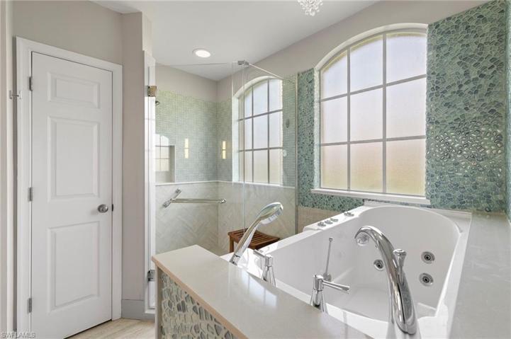This Bath has WOW factor!  Glass tile walls make this bathroom a true oasis.  Walk in tub for convenience!