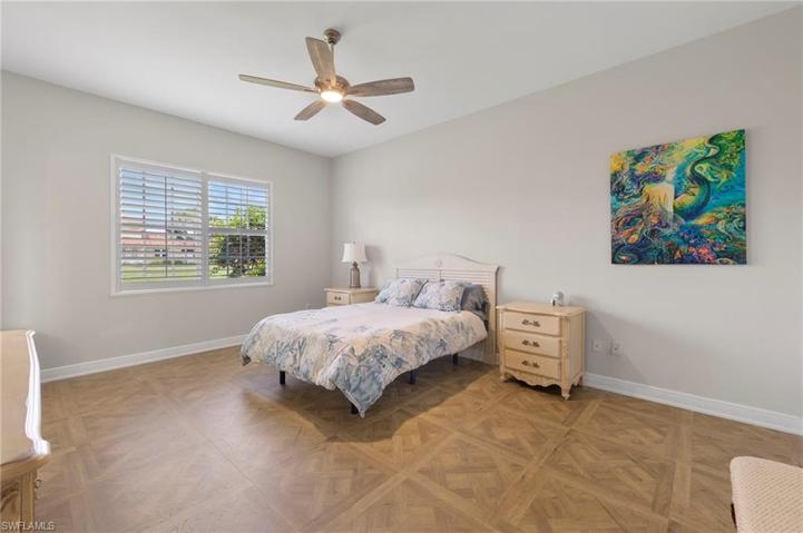 Primary bedroom downstairs overlooks community lake.