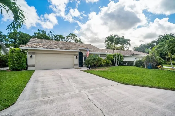 Ranch-style house with a garage and a front yard