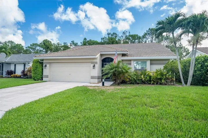 Single story home featuring a garage and a front yard
