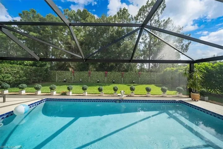 View of pool featuring glass enclosure