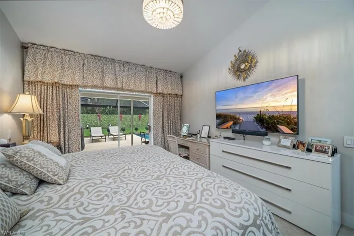 Bedroom with vaulted ceiling and carpet flooring