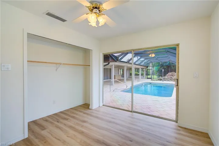 View of swimming pool featuring ceiling fan
