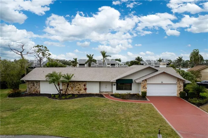 Ranch-style home with a garage and a front yard