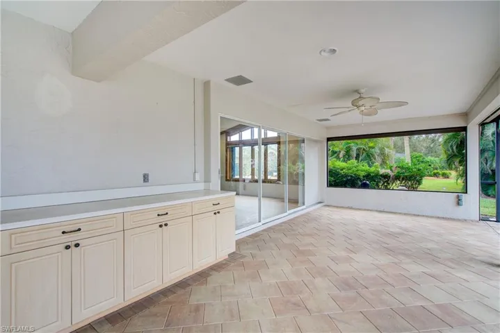 Unfurnished sunroom with ceiling fan
