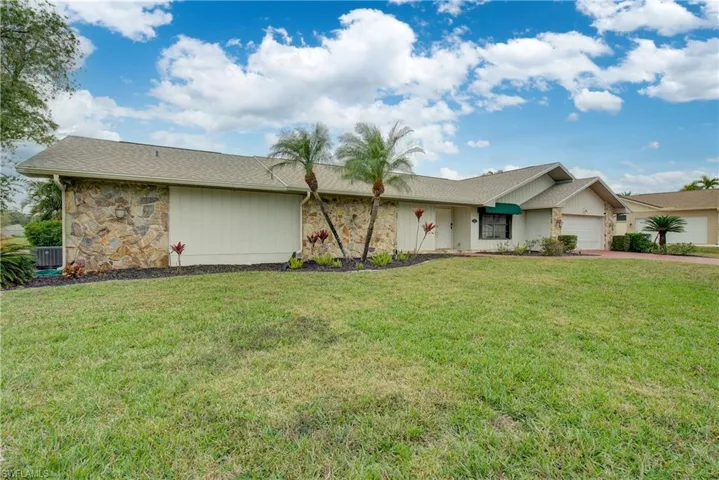 Ranch-style home with a garage and a front yard