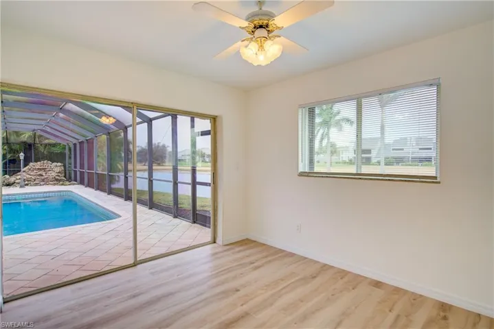 View of swimming pool featuring ceiling fan