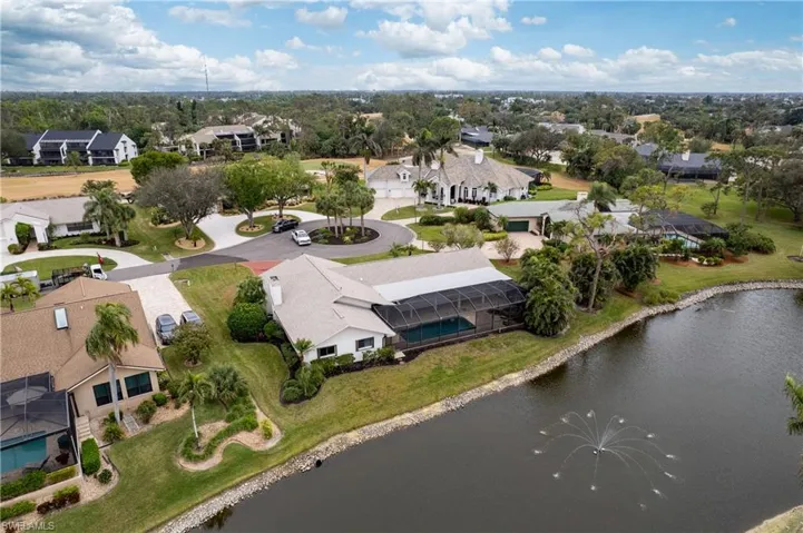 Birds eye view of property with a water view