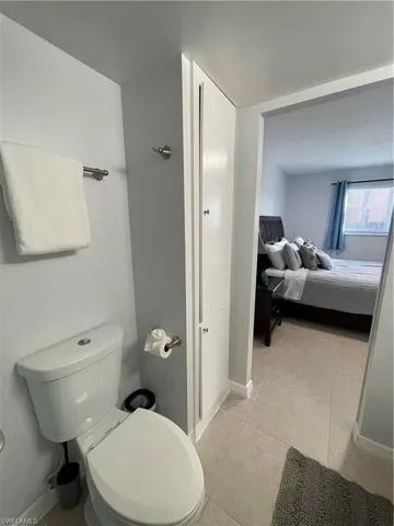 Bathroom featuring light tile patterned flooring and ensuite bath