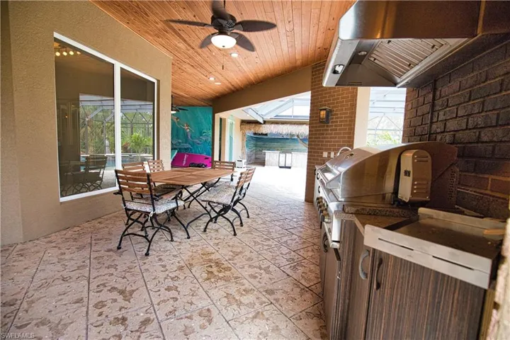 View of patio / terrace with area for grilling, an outdoor kitchen, and ceiling fan