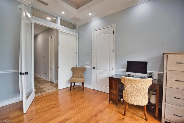 Office featuring light hardwood / wood-style flooring and ornamental molding