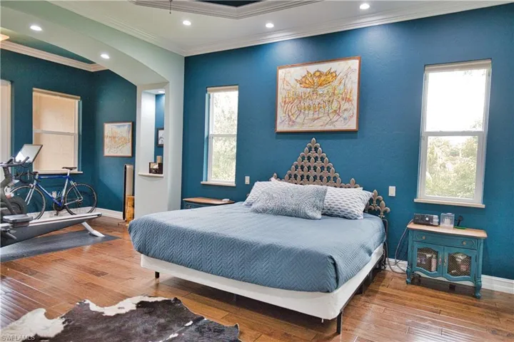 Bedroom featuring ornamental molding and hardwood / wood-style floors