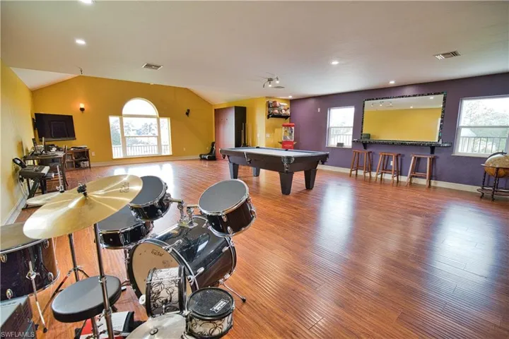 Rec room with hardwood / wood-style flooring, a healthy amount of sunlight, and billiards