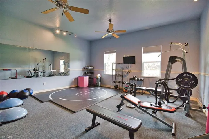 Workout area featuring ceiling fan