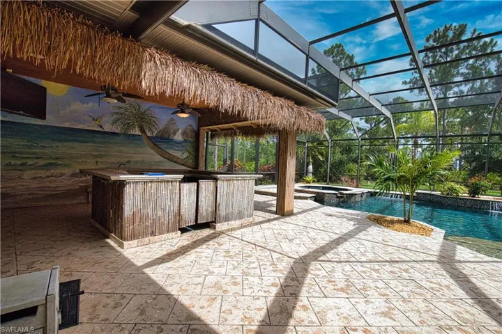 View of pool featuring a patio, an in ground hot tub, a lanai, and ceiling fan