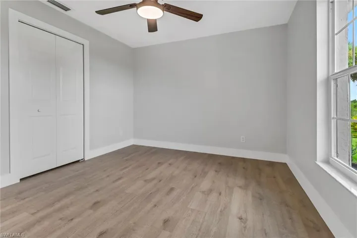 Unfurnished room with ceiling fan and light hardwood / wood-style floors