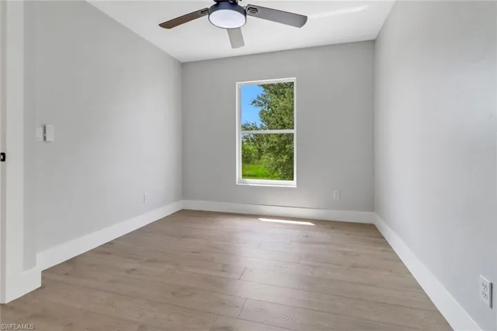 Unfurnished room featuring ceiling fan and light hardwood / wood-style floors